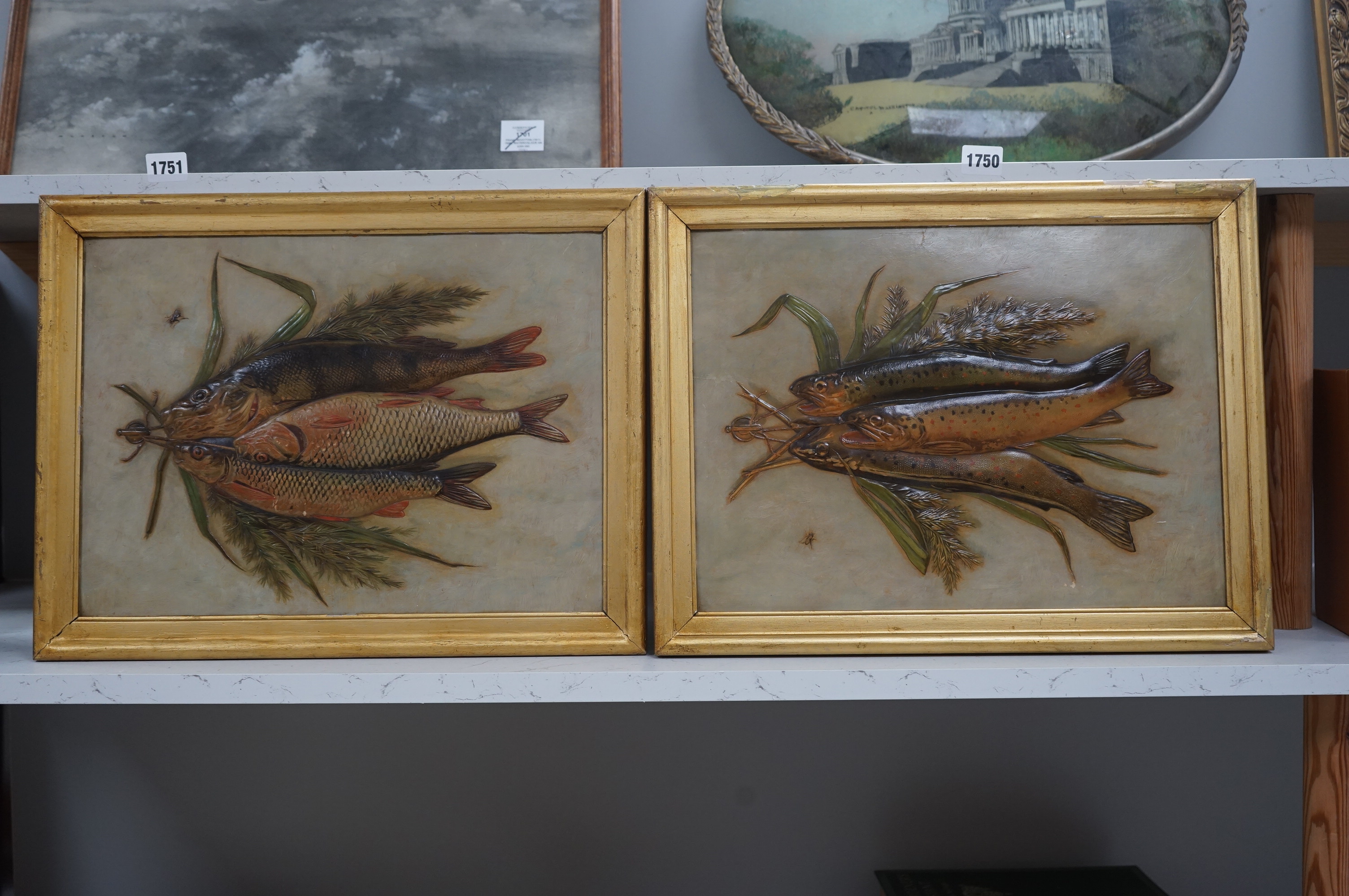 A pair of framed decorative relief 'fish' paintings. 39.5cm wide x 29cm high. Condition - some gilding worn on frames, minor scratches to paintings